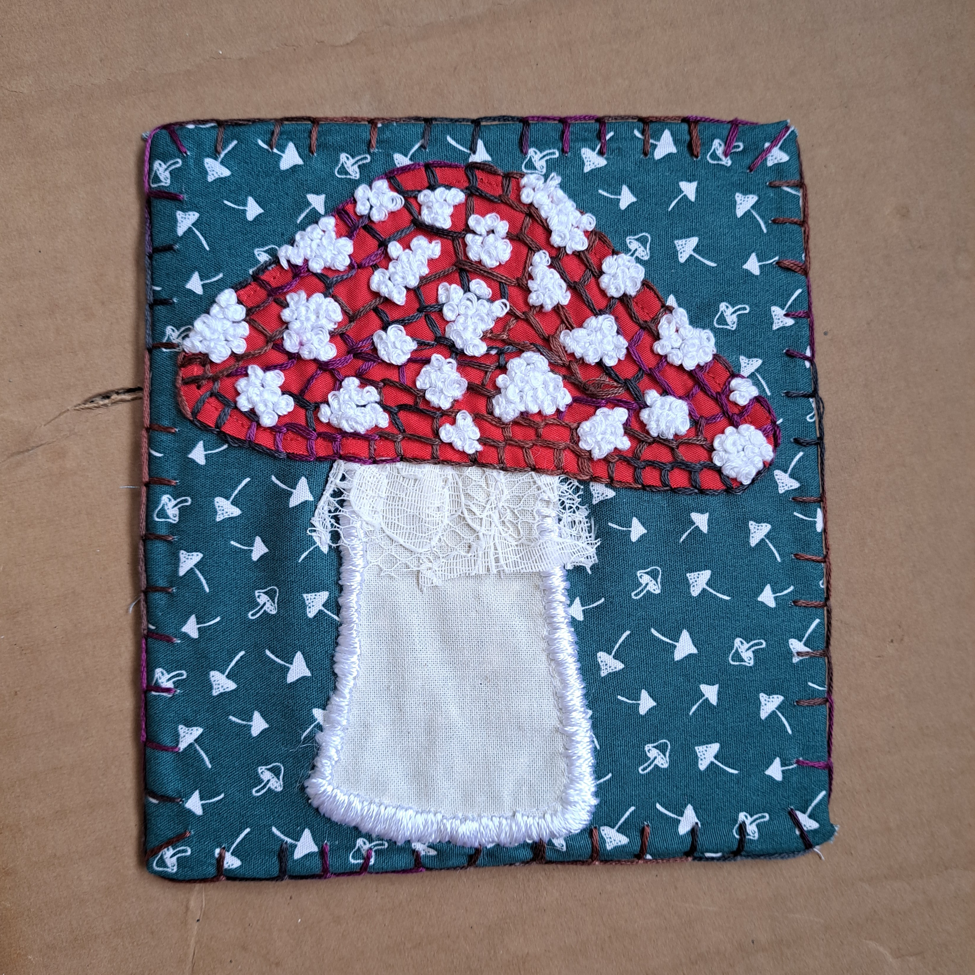 applique toadstool backed on cardboard